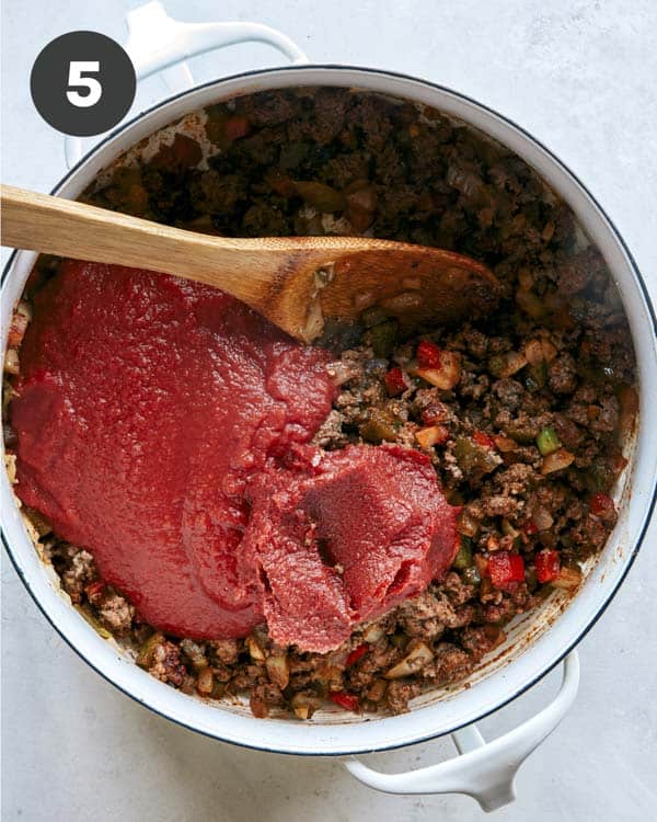 Kitchen sink chili with tomato paste added into the pot. 