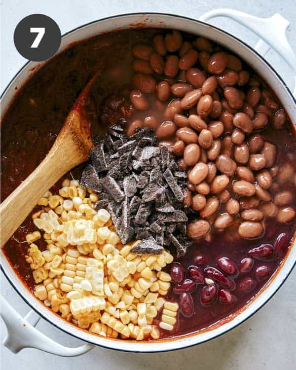 Kitchen sink chili with ingredients being added in. 