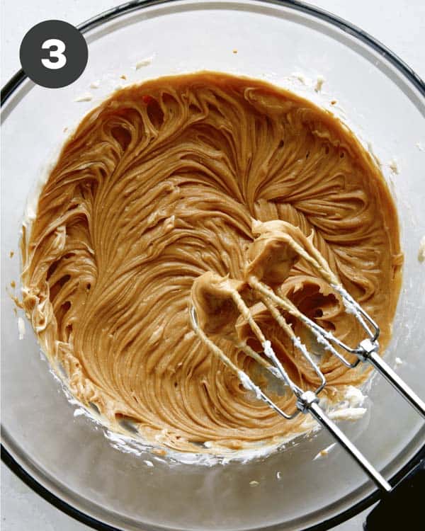 Smooth peanut butter in a bowl for peanut butter frosting.