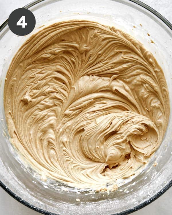 Peanut butter frosting freshly made in a bowl.