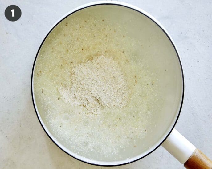 Grits cooking in a pot to make shrimp and grits.