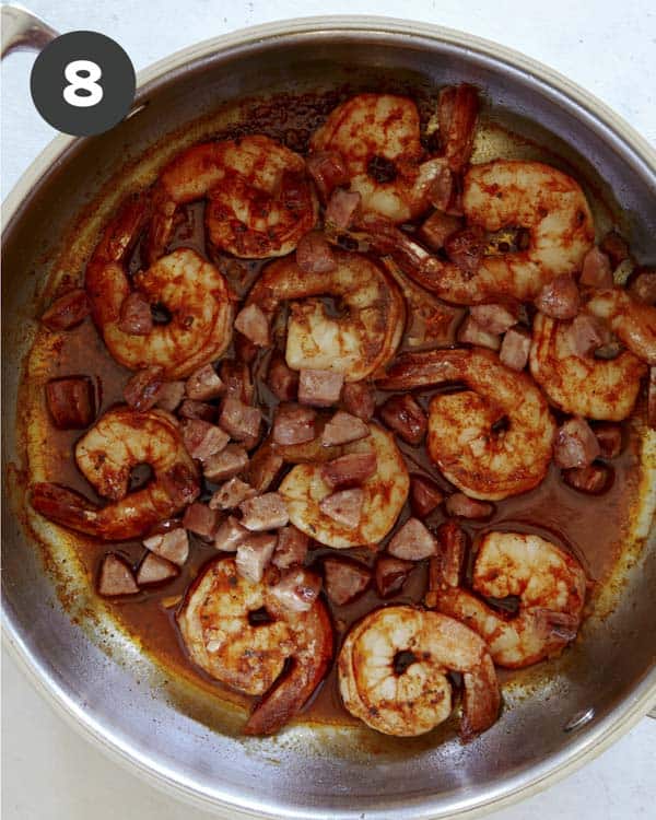 Shrimp and sausage in a skillet for shrimp and grits.