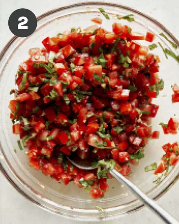Bruschetta ingredients mixed together in a bowl.