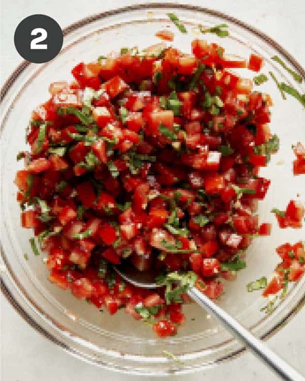 Bruschetta ingredients mixed together in a bowl. 