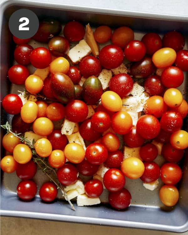 Cherry tomatoes in a roasting pan with butter.