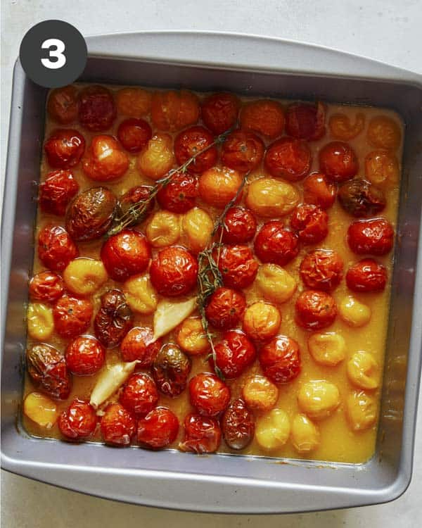 Cherry tomatoes roasted in a baking dish.