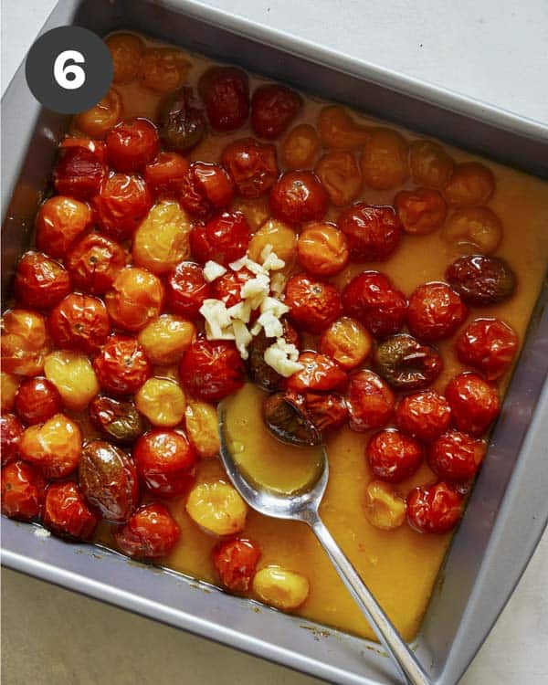 Roasted cherry tomatoes with minced garlic being added back in. 