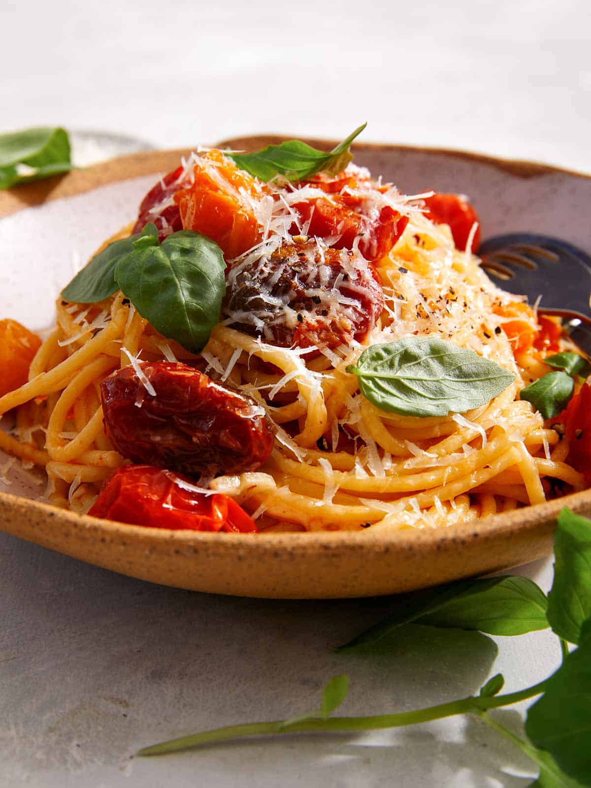 A big pile of butter roasted cherry tomato pasta in a bowl. 