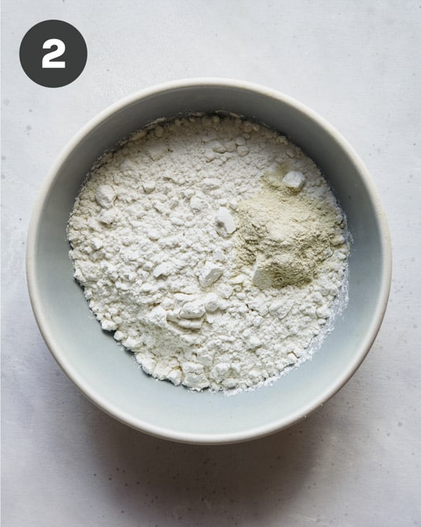 Flour and garlic powder in a bowl for coconut shrimp. 