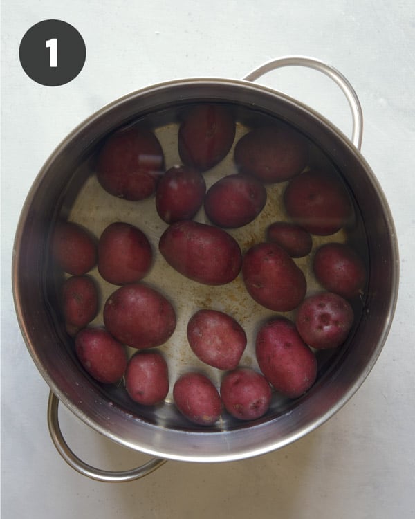 Red potatoes in a pot boiling.