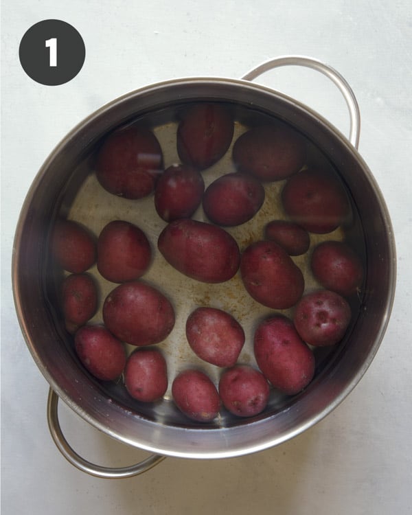 Red potatoes in a pot boiling. 