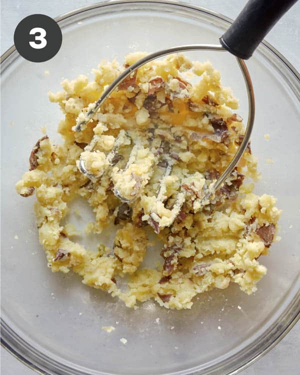 Mashed potatoes in a glass bowl for potato salad.