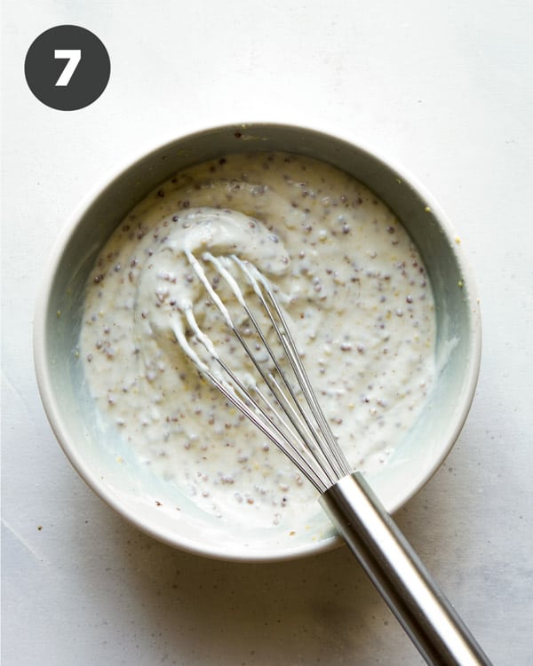 Potato salad dressing in a bowl whisked together.