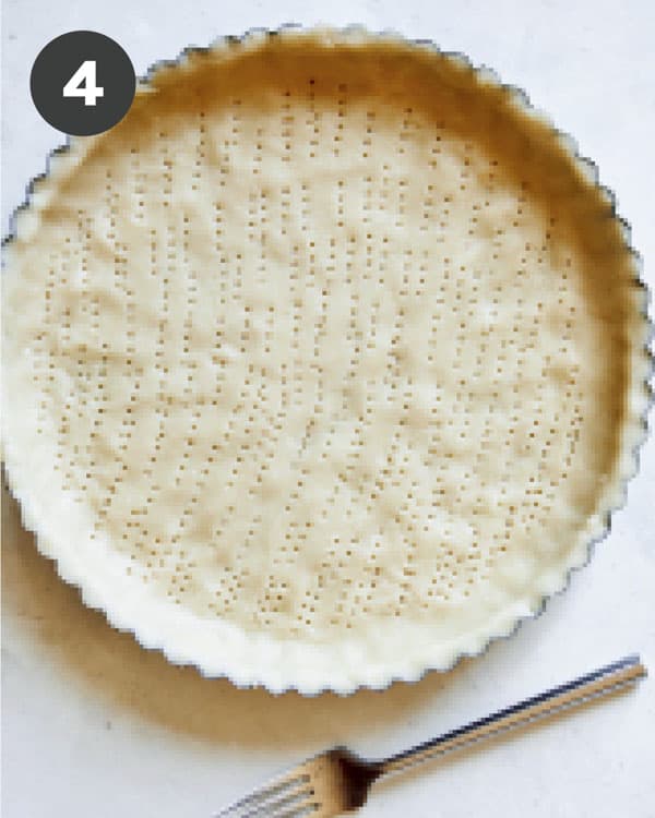 Tart dough pressed into a shell and pricked with a fork.