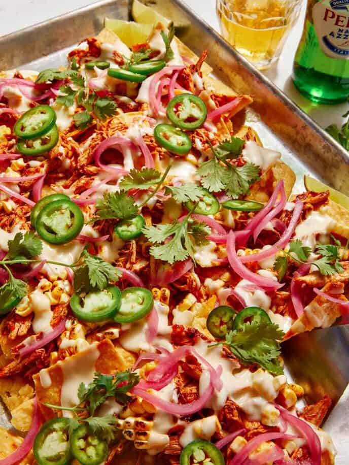 Chipotle chicken sheet pan nachos being served.