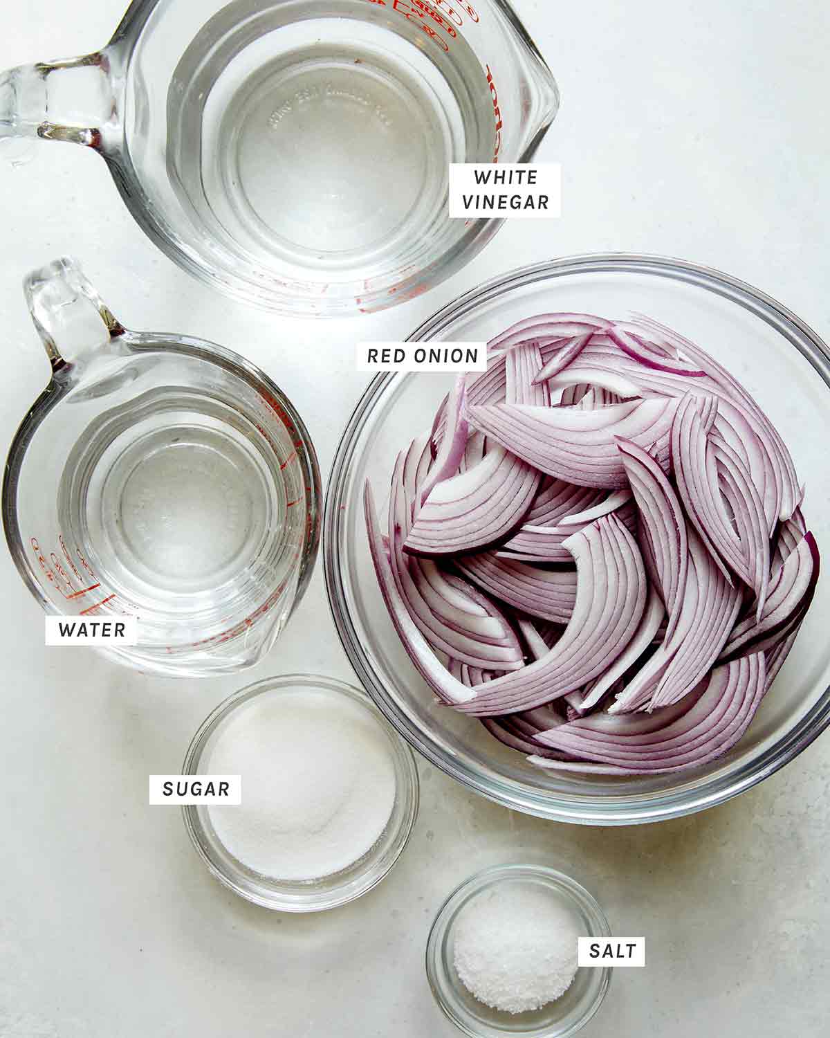Pickled red onion ingredients on a kitchen counter.