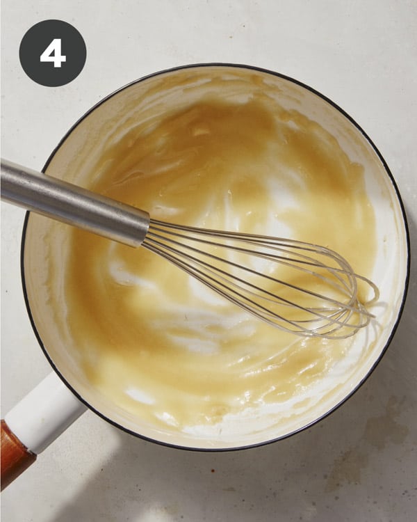 Making the queso sauce in a pot. 