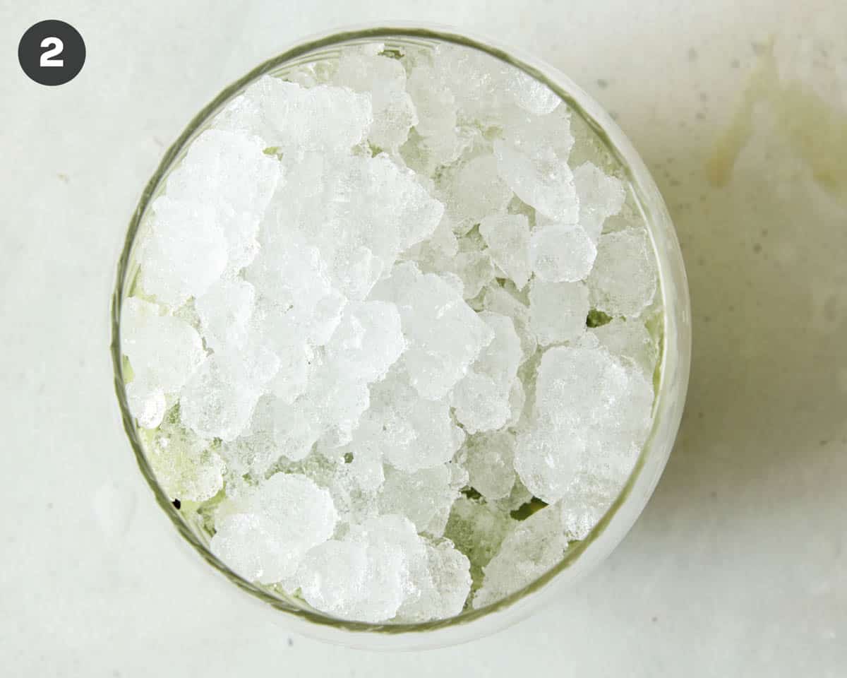 Making a kiwi caipiroska drink recipe.