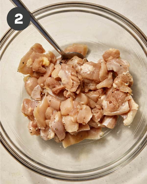 Chicken thighs seasoned with salt and pepper.