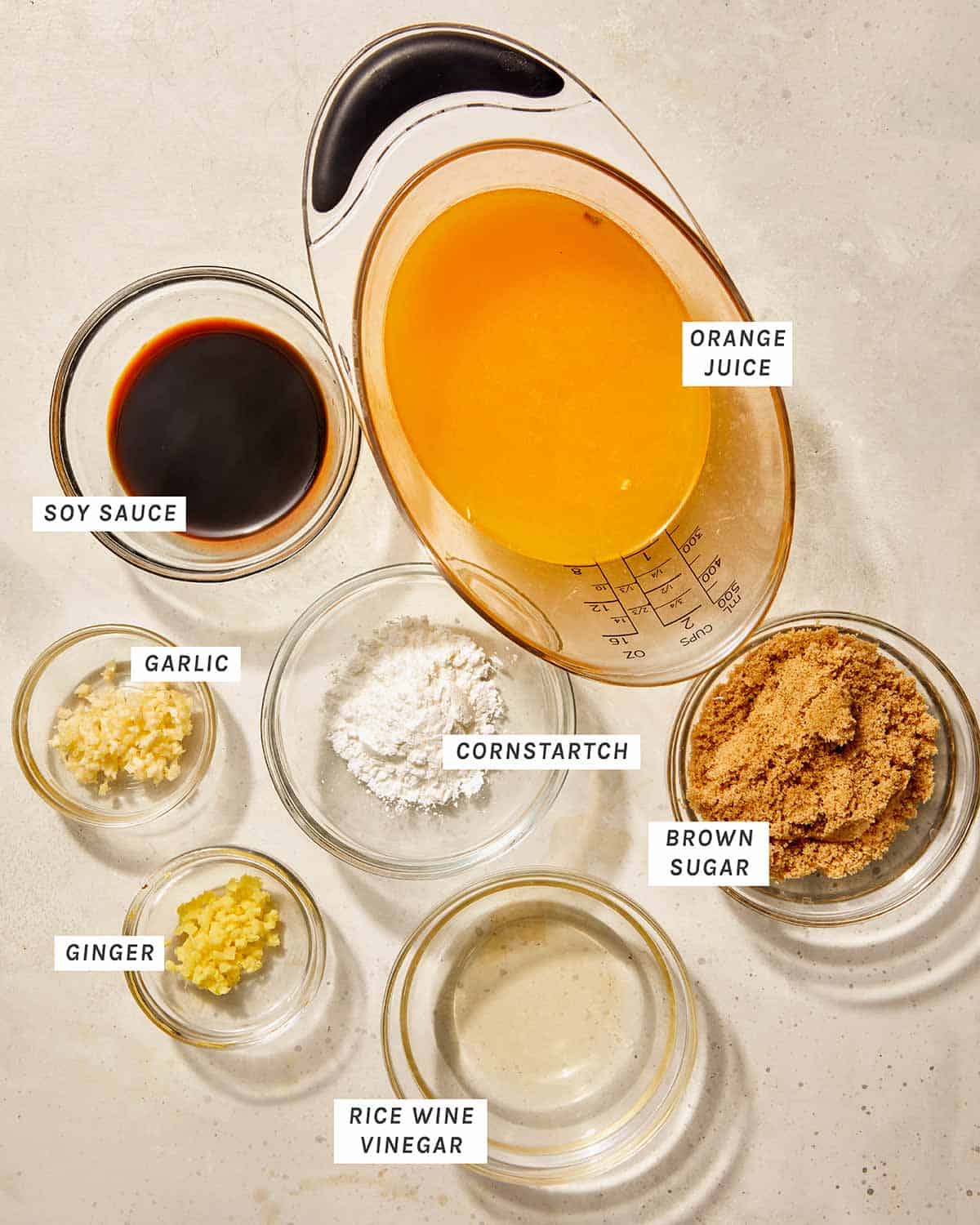 Orange chicken sauce ingredients on a kitchen table.