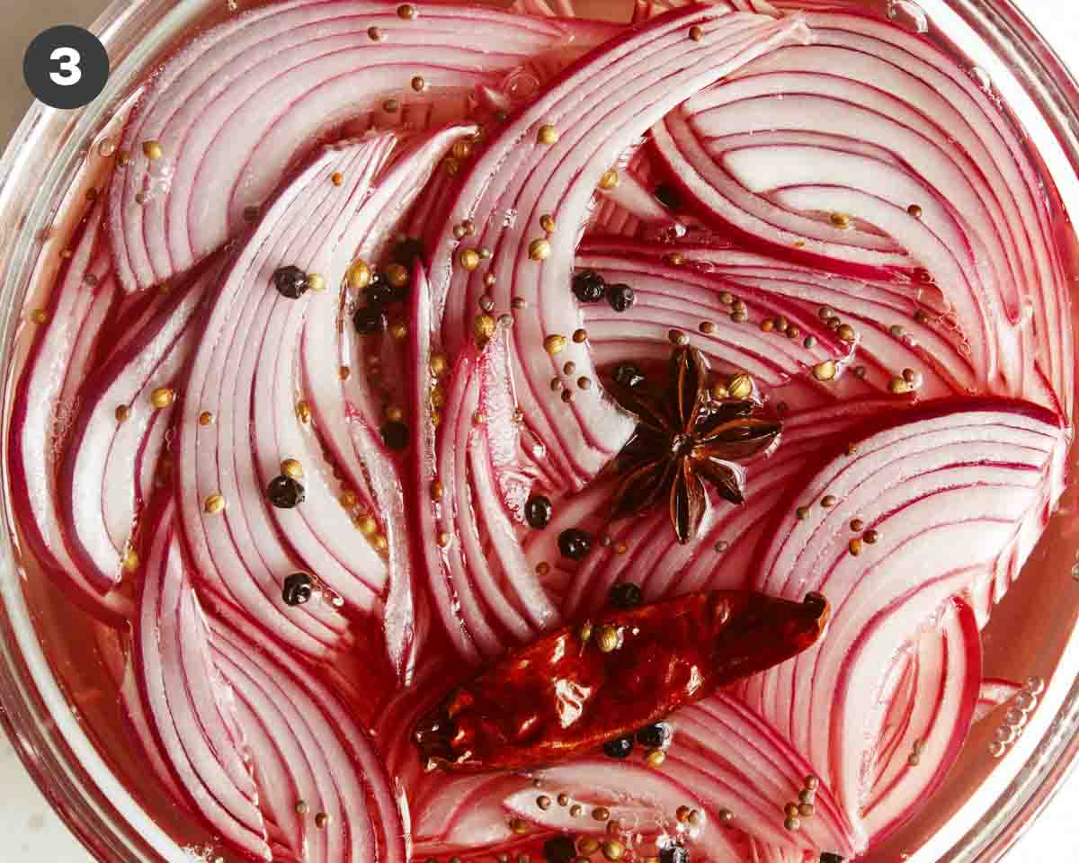 Pickled red onion in a jar to rest in the refrigerator.