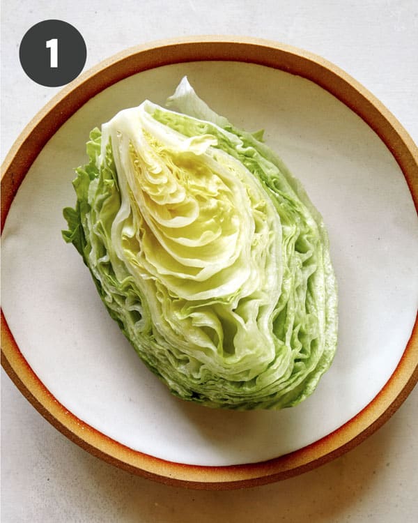 A wedge of lettuce on a platter. 