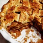 A view into a slice of apple pie with cheddar crust.