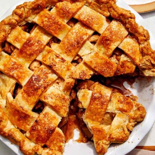 Brown butter apple pie recipe with a cheddar crust and a slice taken out.