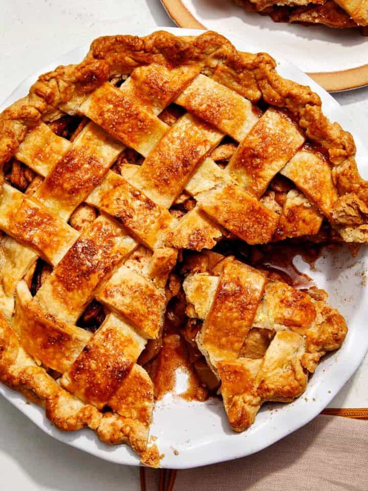 Brown butter apple pie recipe with a cheddar crust and a slice taken out.