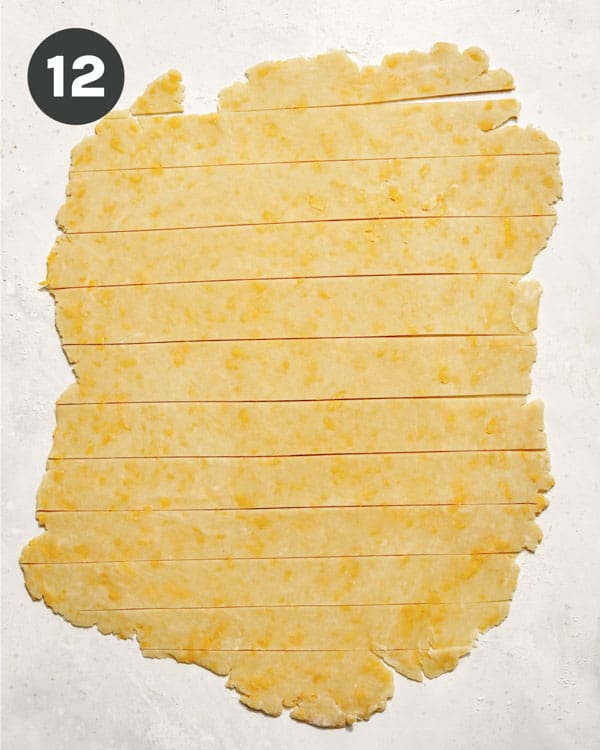 Pie crust being cut into strips.