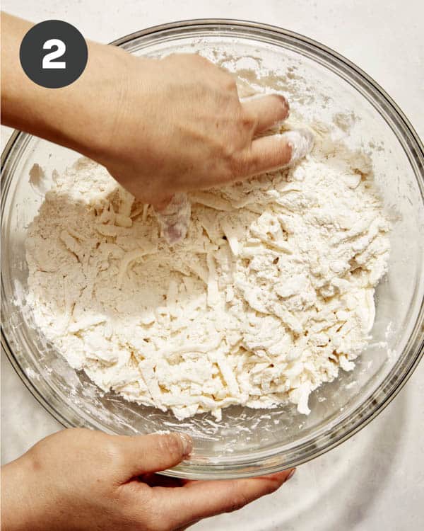 Flour mixture with butter being cut in for apple pie. 