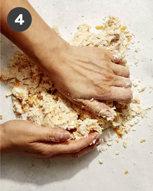 Pie crust being kneaded. 