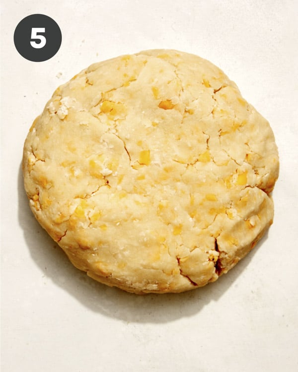 Apple pie with a cheddar crust formed into a disc.