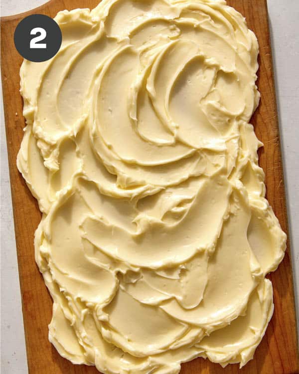 Room temperature butter smeared onto a board. 