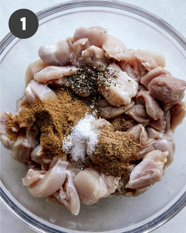 Butter chicken spices and chicken in a bowl.