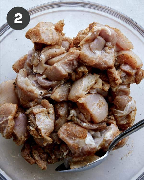 Spiced chicken for butter chicken raw in a bowl.