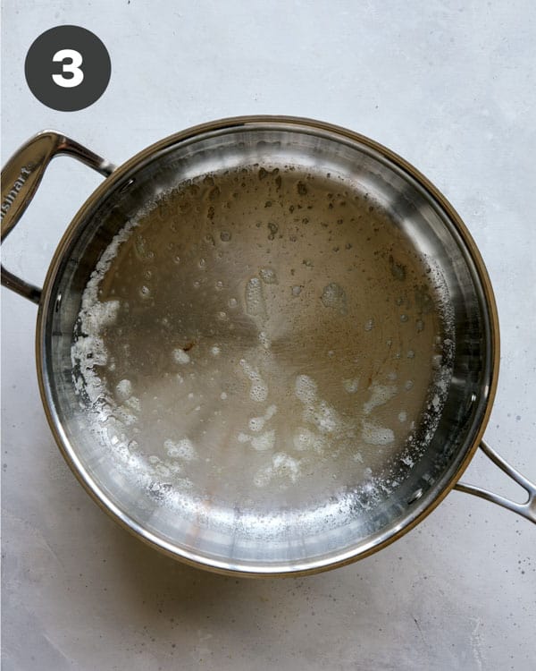 Skillet with melted butter to make butter chicken. 