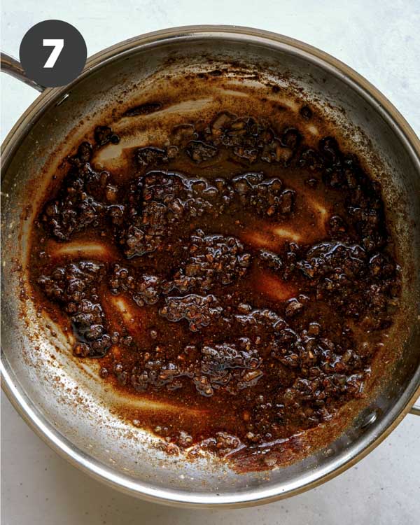 Skillet with spices to make butter chicken sauce.