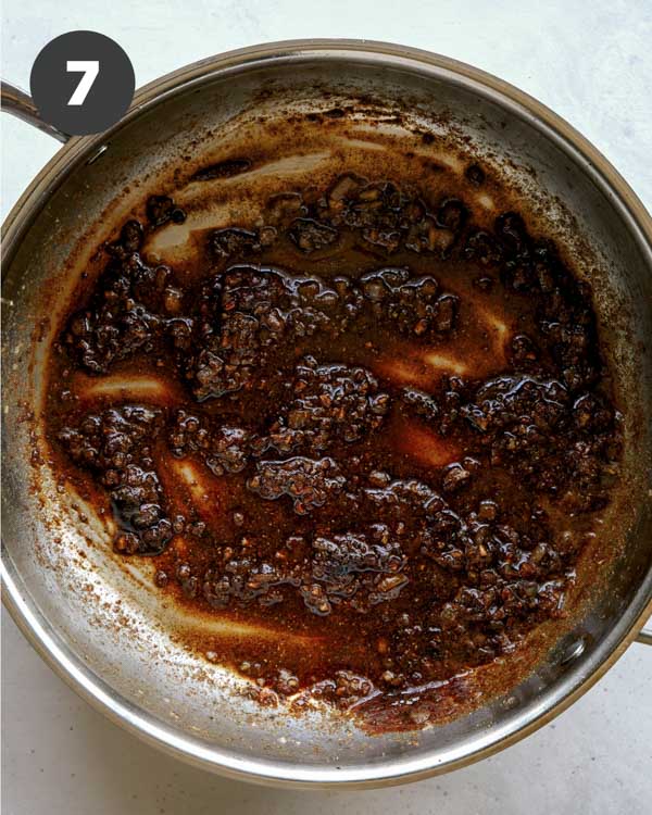 Skillet with spices to make butter chicken sauce. 