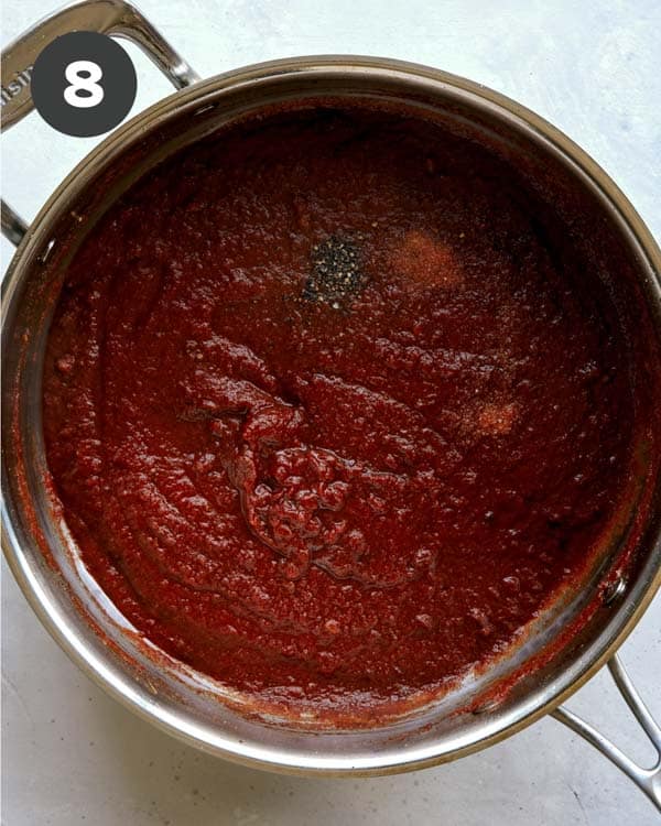 Butter chicken sauce in a skillet simmering.