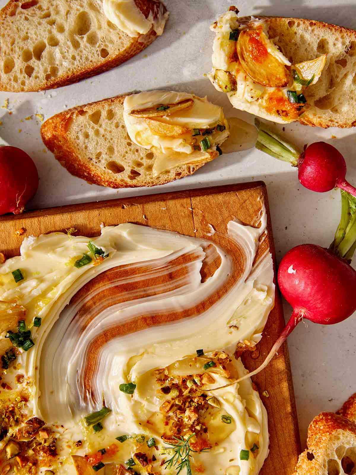 Butter board recipe with bread dipped in it. 
