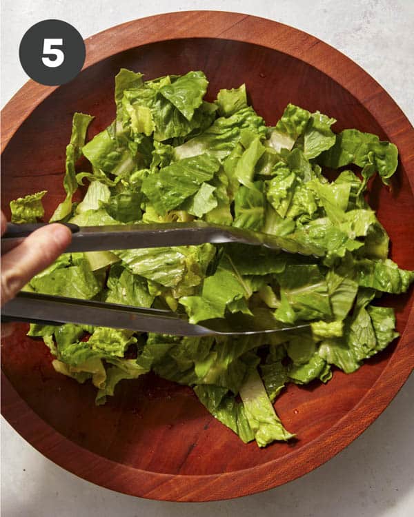 Lettuce tossed in a red wine vinaigrette for a greek salad.