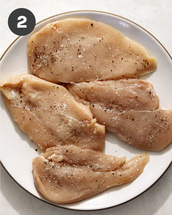 Chicken breasts seasoned with salt and pepper. 