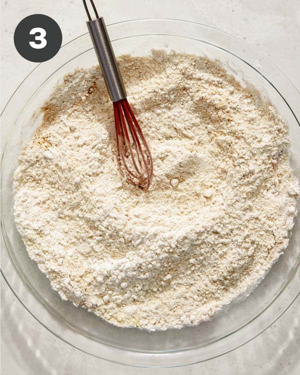 Flour mixture in a shallow baking dish to make hot honey chicken sandwiches. 