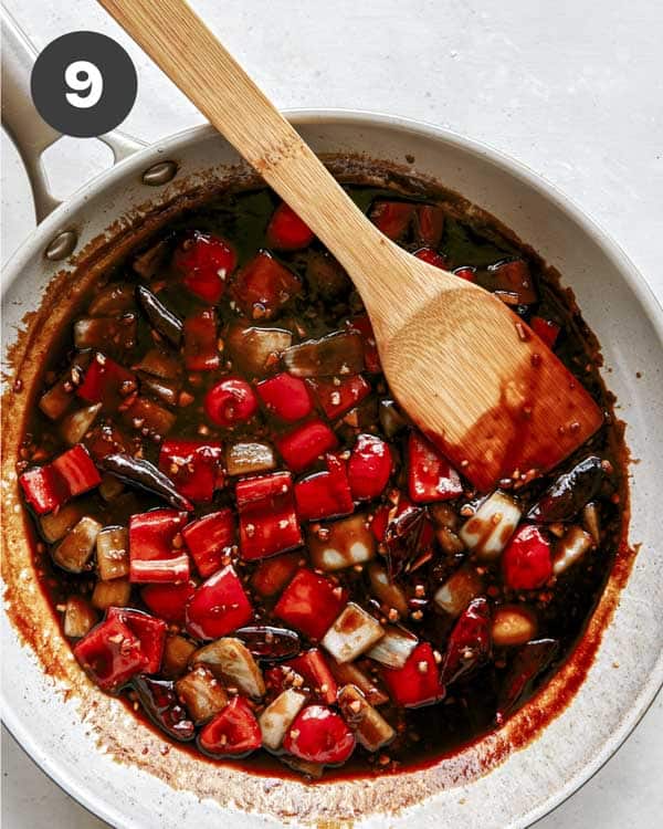 Kung pao sauce cooking in a skillet.