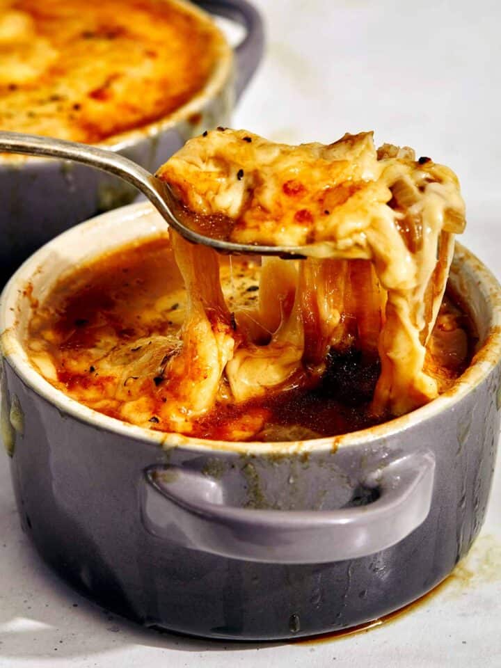 French onion soup with a spoon in it.