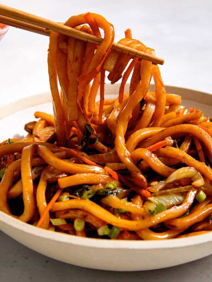 Yaki udon noodle recipe in a bowl with chopsticks.