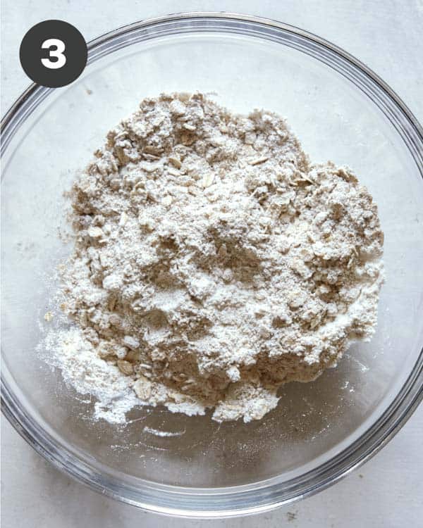 Apple crisps topping mixed together in a bowl.