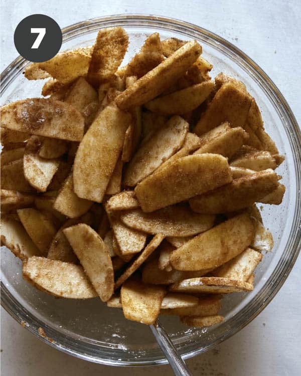 Apple crisp filling mixed together in a bowl. 