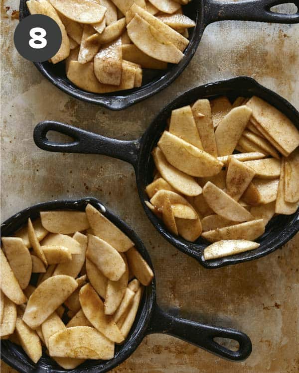 Apple crisps filling in cast iron skillets.